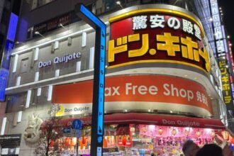 Don Quijote discount store bright signage and exterior in Shinjuku at night