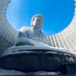 Head of the Buddha statue visible above lavender fields in Sapporo attraction