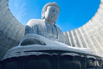 Head of the Buddha statue visible above lavender fields in Sapporo attraction